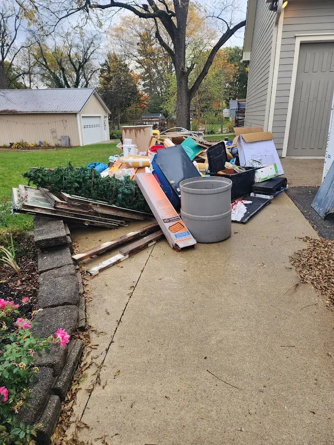 Dumpster being loaded with debris for 10 Yard Dumpster Rental in Helotes
